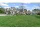 Beautiful home exterior with a spacious backyard, pool, pergola, and lush greenery at 710 Cox Rd, Roswell, GA 30075