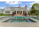 Beautiful home showcasing a backyard swimming pool and patio for elegant outdoor living and entertaining at 710 Cox Rd, Roswell, GA 30075