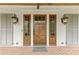 Charming front door with sidelights, brick porch, and stylish outdoor lanterns at 710 Cox Rd, Roswell, GA 30075