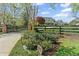 Inviting traditional home with black gated entrance, lush landscaping and stone address plaque at 710 Cox Rd, Roswell, GA 30075