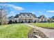 Stunning home with a well-manicured lawn, brick walkway and charming front porch at 710 Cox Rd, Roswell, GA 30075