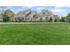 Charming two-story home with a manicured lawn, bordered by mature trees and decorative landscaping at 710 Cox Rd, Roswell, GA 30075
