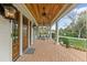 Inviting front porch with swing seating and detailed ceiling and brick floor at 710 Cox Rd, Roswell, GA 30075