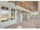 Covered porch with brick floor, ceiling fans, and seating area for relaxation at 710 Cox Rd, Roswell, GA 30075