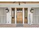 Charming front entrance with double doors, stylish shutters, and lantern lighting at 710 Cox Rd, Roswell, GA 30075