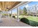 Inviting front porch with brick flooring, ceiling fans, and comfortable porch swing at 710 Cox Rd, Roswell, GA 30075