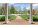 Picturesque view from the porch, framed by elegant columns and lush landscaping at 710 Cox Rd, Roswell, GA 30075