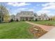 Stunning two-story home with a manicured lawn and a charming brick walkway leading to the entrance at 710 Cox Rd, Roswell, GA 30075