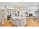 Kitchen with stainless appliances, kitchen island, pendant lighting, and view to the living room at 710 Cox Rd, Roswell, GA 30075