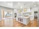 Bright, airy kitchen featuring a large island, modern appliances, and an adjacent breakfast nook with brick walls at 710 Cox Rd, Roswell, GA 30075