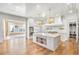 Bright kitchen with white cabinets, large island, stone countertops, and hardwood floors at 710 Cox Rd, Roswell, GA 30075