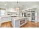 Gorgeous kitchen with stainless appliances, large island, pendant lighting, and hardwood floors at 710 Cox Rd, Roswell, GA 30075