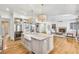 Stylish kitchen open to living room includes an island with a farmhouse sink, and stainless steel refrigerator at 710 Cox Rd, Roswell, GA 30075