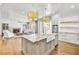 Modern kitchen open to the living room features a large island with seating and stainless appliances at 710 Cox Rd, Roswell, GA 30075