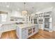 Open kitchen boasts a spacious island with stone countertops, custom cabinetry, and stainless steel appliances at 710 Cox Rd, Roswell, GA 30075