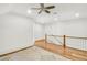 A spacious landing is lit with recessed lights, a hardwood floor, and a wooden banister at 710 Cox Rd, Roswell, GA 30075