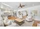Open-concept space with living room, kitchen, and staircase with hardwood floors throughout at 710 Cox Rd, Roswell, GA 30075
