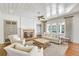 Elegant living room with fireplace, lots of seating, and natural light at 710 Cox Rd, Roswell, GA 30075