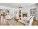 Open-concept living room with hardwood floors, a fireplace, and access to the foyer at 710 Cox Rd, Roswell, GA 30075