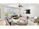 Comfortable living room featuring a plush sectional sofa, natural light, hardwood floors, and a ceiling fan at 710 Cox Rd, Roswell, GA 30075