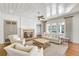 Cozy living room with fireplace, built-in cabinets, and comfortable seating area at 710 Cox Rd, Roswell, GA 30075