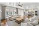 Open-concept living space with hardwood floors, a kitchen, and access to the exterior at 710 Cox Rd, Roswell, GA 30075