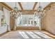 Stunning living room featuring exposed brick walls, wood beams, and elegant chandeliers at 710 Cox Rd, Roswell, GA 30075