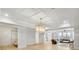 Open-concept living space with hardwood floors, coffered ceilings, decorative chandelier, and view to sitting area at 710 Cox Rd, Roswell, GA 30075