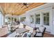 Charming outdoor patio with a wood-paneled ceiling, comfortable seating, and a stylish rug at 710 Cox Rd, Roswell, GA 30075