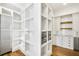 Walk-in pantry with custom shelving, cabinets, drawers, storage baskets, and stainless refrigerator at 710 Cox Rd, Roswell, GA 30075