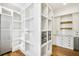 Organized walk-in pantry featuring custom shelving, built-in storage, and easy access to the kitchen at 710 Cox Rd, Roswell, GA 30075