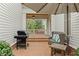 Cozy outdoor patio with a grill, comfortable seating, and a view of the well-maintained backyard at 710 Cox Rd, Roswell, GA 30075