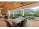 Inviting covered patio with a brick fireplace, wood ceiling, and outdoor dining area overlooking the pool at 710 Cox Rd, Roswell, GA 30075