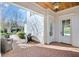 Charming covered patio with a brick floor, seating, and grill for comfortable outdoor living at 710 Cox Rd, Roswell, GA 30075