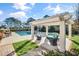 Relaxing backyard pergola with comfortable seating overlooking the pool and manicured lawn, perfect for outdoor entertaining at 710 Cox Rd, Roswell, GA 30075