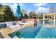 Inviting pool with sun loungers and a waterfall feature, creating a serene and luxurious outdoor space at 710 Cox Rd, Roswell, GA 30075