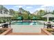 Backyard pool featuring a sun shelf, tables, and lounge chairs perfect for outdoor relaxation and entertainment at 710 Cox Rd, Roswell, GA 30075