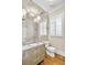 Chic powder room features an ornate vanity, decorative mirror wall, and plantation shutters at 710 Cox Rd, Roswell, GA 30075