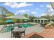 Backyard pool with patio seating, umbrellas, tanning ledge, and gazebo offers a luxurious outdoor retreat at 710 Cox Rd, Roswell, GA 30075