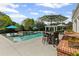 Beautiful backyard pool with tanning ledge, patio seating, and pergola provides an ideal entertaining space at 710 Cox Rd, Roswell, GA 30075