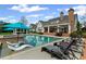 Lounge by the backyard pool complete with tanning ledge, outdoor seating, and a spa for ultimate relaxation at 710 Cox Rd, Roswell, GA 30075