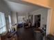 Bright living room showcasing hardwood floors, crown molding, and large windows at 405 Baneberry Bnd, Peachtree City, GA 30269