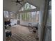 Inviting sunroom with wood flooring and walls of windows offering serene views at 405 Baneberry Bnd, Peachtree City, GA 30269