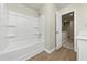 Bathroom with a tub, shower, and access to hallway at 527 Firethorn Ct, Villa Rica, GA 30180