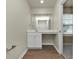 Small bathroom with single vanity, mirror and wood-look floor at 527 Firethorn Ct, Villa Rica, GA 30180