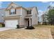 Two-story house with brick and siding, two-car garage, and landscaped yard at 527 Firethorn Ct, Villa Rica, GA 30180