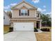 Two-story house with brick and siding, two-car garage, and landscaped yard at 527 Firethorn Ct, Villa Rica, GA 30180