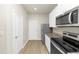 Kitchen with white cabinets, granite counters, and stainless steel appliances at 527 Firethorn Ct, Villa Rica, GA 30180