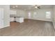 Open living area with kitchen island, wood-look floors, and ceiling fan at 527 Firethorn Ct, Villa Rica, GA 30180