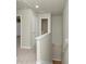 Upstairs hallway with neutral paint and carpet, leading to bedrooms at 527 Firethorn Ct, Villa Rica, GA 30180